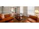 Bright living room with hardwood floors, comfortable seating, and a view into the entry at 1560 Boxwood Nw Trce, Acworth, GA 30102