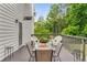 Outdoor patio with table and chairs and lush green trees in background at 1560 Boxwood Nw Trce, Acworth, GA 30102