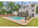 An in-ground pool sits in a backyard featuring a deck and green grass at 1560 Boxwood Nw Trce, Acworth, GA 30102