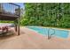In-ground swimming pool with concrete surrounding and lush green trees in background at 1560 Boxwood Nw Trce, Acworth, GA 30102