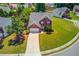 Aerial view of a brick two-story home showcasing its landscaped yard and neighborhood at 2990 Haynes Club Cir, Grayson, GA 30017