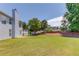 Spacious backyard with lush lawn surrounded by mature trees, showcasing ample space for outdoor activities at 2990 Haynes Club Cir, Grayson, GA 30017