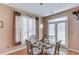 Charming dining room featuring a glass table and a window overlooking the yard, creating an inviting space at 2990 Haynes Club Cir, Grayson, GA 30017