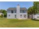 View of the back exterior of the home with large yard and ample trees at 2990 Haynes Club Cir, Grayson, GA 30017