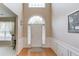 Elegant foyer with hardwood floors, decorative molding, and a glimpse of the staircase at 2990 Haynes Club Cir, Grayson, GA 30017