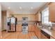 Well-lit kitchen with stainless steel appliances, plenty of counter space, and classic wooden cabinets at 2990 Haynes Club Cir, Grayson, GA 30017