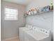 Practical laundry room with washer, dryer, and shelving for storage to keep everything organized at 2990 Haynes Club Cir, Grayson, GA 30017