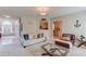 Bright, open living room with hardwood floors, comfortable seating, and easy access to the kitchen at 2990 Haynes Club Cir, Grayson, GA 30017