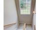Well-lit staircase with a view to the backyard from the upper landing, adding natural light at 2990 Haynes Club Cir, Grayson, GA 30017