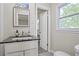 Powder room featuring a black granite countertop on white vanity and mirror at 4025 Cheoah Dr, Douglasville, GA 30135