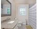 Bathroom with granite countertop sink, toilet, and shower with gray tiled flooring at 4025 Cheoah Dr, Douglasville, GA 30135