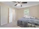 Bedroom with blue bedspread, a ceiling fan, and an open bathroom doorway at 4025 Cheoah Dr, Douglasville, GA 30135