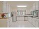 Bright kitchen featuring white cabinets, modern appliances, and stylish marble floors at 4025 Cheoah Dr, Douglasville, GA 30135