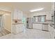 Bright kitchen featuring white cabinets, modern appliances, and stylish marble floors at 4025 Cheoah Dr, Douglasville, GA 30135
