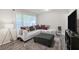 Bright living room with white couch, ottoman, and gray wood laminate flooring at 4025 Cheoah Dr, Douglasville, GA 30135