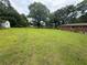Expansive backyard with lush green grass and mature trees, perfect for recreation at 5167 Hiram Lithia Springs Rd, Powder Springs, GA 30127