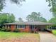 Charming single-story brick home with a covered porch and a well-maintained front yard at 5167 Hiram Lithia Springs Rd, Powder Springs, GA 30127