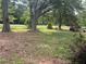 Spacious front yard featuring mature trees, offering a blend of shade and sunlight at 5167 Hiram Lithia Springs Rd, Powder Springs, GA 30127