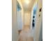 Hallway with three doorways, carpeted floors, and access to other rooms in the home at 5167 Hiram Lithia Springs Rd, Powder Springs, GA 30127