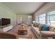 Comfortable living room with a sofa, area rug, and large windows for natural light at 5167 Hiram Lithia Springs Rd, Powder Springs, GA 30127