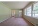 Cozy living room featuring large windows, neutral paint, and plush carpeting at 5167 Hiram Lithia Springs Rd, Powder Springs, GA 30127