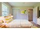 Comfortable bedroom featuring a bed, closet, and natural light from a large window at 5167 Hiram Lithia Springs Rd, Powder Springs, GA 30127