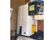 Modern, energy-efficient tankless water heater with visible energy guide label at 5167 Hiram Lithia Springs Rd, Powder Springs, GA 30127