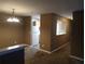 Inviting dining area with adjacent kitchen view, illuminated by a chandelier, and ample natural light at 8202 Fairington Village Dr, Lithonia, GA 30038
