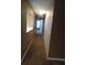 Long, narrow hallway illuminated by a ceiling light, offering access to different areas of the house at 8202 Fairington Village Dr, Lithonia, GA 30038