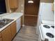 Galley kitchen featuring wooden cabinets, laminate countertops, and white appliances at 8202 Fairington Village Dr, Lithonia, GA 30038