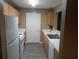 Modern kitchen with wooden cabinets, laminate countertops and stainless steel sink at 8202 Fairington Village Dr, Lithonia, GA 30038