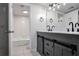 Well-lit bathroom with double sinks, gray vanity, and a shower/tub combination at 1150 Collier Nw Rd # K9, Atlanta, GA 30318