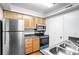 Functional kitchen featuring stainless steel appliances, granite counters, and wooden cabinets at 1150 Collier Nw Rd # K9, Atlanta, GA 30318