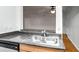 Well-lit kitchen featuring a stainless steel double sink and gray granite countertops at 1150 Collier Nw Rd # K9, Atlanta, GA 30318