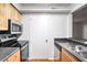 Well-equipped kitchen featuring stainless steel appliances, granite counters, and wooden cabinets at 1150 Collier Nw Rd # K9, Atlanta, GA 30318
