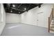 Unfinished basement with painted concrete floors and open ceiling with exposed ductwork at 3427 Mill Stream Sw Ln, Marietta, GA 30060
