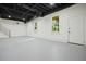 Unfinished basement with concrete floors, white walls, and windows looking out on wooded yard at 3427 Mill Stream Sw Ln, Marietta, GA 30060