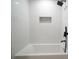 Modern bathroom with white tiles, black fixtures, and a built-in shower niche at 3427 Mill Stream Sw Ln, Marietta, GA 30060