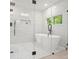 Bright bathroom features a soaking tub, glass shower, window, and mosaic tiled floors at 3427 Mill Stream Sw Ln, Marietta, GA 30060