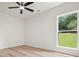 Bedroom with wood floor, ceiling fan, and backyard view from the window at 3427 Mill Stream Sw Ln, Marietta, GA 30060