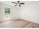 Bright bedroom with wood floors, ceiling fan, and backyard view from the window at 3427 Mill Stream Sw Ln, Marietta, GA 30060