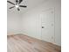 Minimalist bedroom features wood floors, ceiling fan, and white trim at 3427 Mill Stream Sw Ln, Marietta, GA 30060