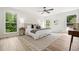 Sunlit bedroom boasts a modern ceiling fan, hardwood floors, and bright white walls at 3427 Mill Stream Sw Ln, Marietta, GA 30060