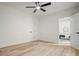 Bedroom featuring wood floors, a ceiling fan, and an open door to another room at 3427 Mill Stream Sw Ln, Marietta, GA 30060