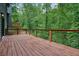 Large wooden deck with wood and iron railings overlooking a lush green wooded area at 3427 Mill Stream Sw Ln, Marietta, GA 30060