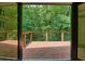Exterior deck through French doors with wood railings, and overlooking private wooded area at 3427 Mill Stream Sw Ln, Marietta, GA 30060