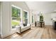 Bright dining area with large windows offering scenic views and a modern bench at 3427 Mill Stream Sw Ln, Marietta, GA 30060