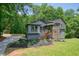 Charming two-story home featuring gray siding, wood porch and a beautifully landscaped yard at 3427 Mill Stream Sw Ln, Marietta, GA 30060