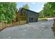 Exterior shot reveals two-story home with a two-car garage and an elevated deck on the side at 3427 Mill Stream Sw Ln, Marietta, GA 30060