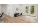 Hallway with wood floors, black bench with pillows, and double doors to the outside at 3427 Mill Stream Sw Ln, Marietta, GA 30060